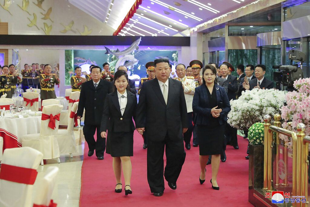 In this photo provided by the North Korean government, North Korean leader Kim Jong Un, center left, with his daughter attends a military parade to mark the 75th founding anniversary of the Korean People's Army on Kim Il Sung Square in Pyongyang, North Korea Wednesday, Feb. 8, 2023. Independent journalists were not given access to cover the event depicted in this image distributed by the North Korean government. The content of this image is as provided and cannot be independently verified. Korean language watermark on image as provided by source reads: 
