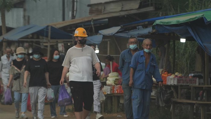 Sejumlah Tenaga Kerja Asing (TKA) berjalan di pasar yang berada di depan sebuah perusahaan smelter, Kecamatan Morosi, Konawe, Sulawesi Tenggara, Rabu (8/2/2023). Dinas Tenaga Kerja Transmigrasi (Disnakertrans) Provinsi Sulawesi Tenggara mencatat sekitar dua ribu TKA dari China itu bekerja di dua perusahaan smelter yaitu PT Virtue Dragon Nickel Industry (VDNI) dan PT Obsidian Stainless Steel (OSS). ANTARA FOTO/Jojon/tom.