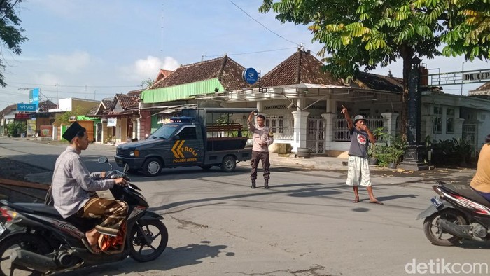 Polisi dan warga menutup jalan Ceper-Pedan karena ada tiang ambruk, Klaten, Jumat (10/2/2023).