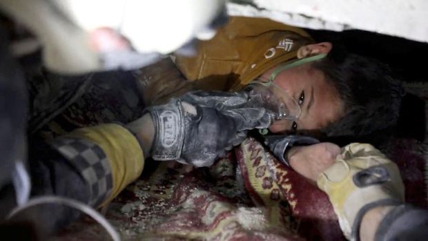 A child is rescued from the rubble in the aftermath of an earthquake in Azmarin, Syria, February 7, 2023 in this still image taken from video.  White Helmets/Handout via REUTERS    THIS IMAGE HAS BEEN SUPPLIED BY A THIRD PARTY. NO RESALES. NO ARCHIVES. MANDATORY CREDIT