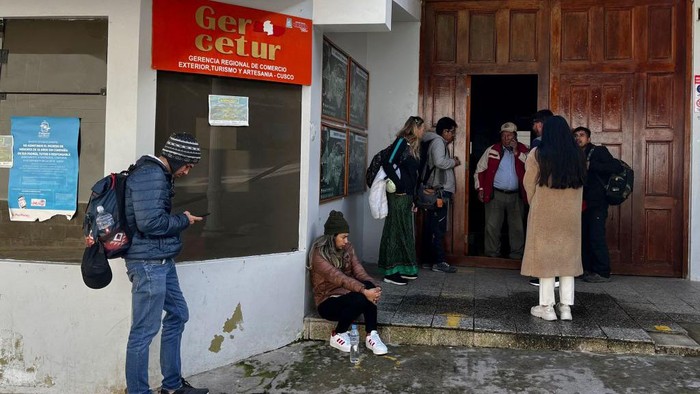 People gather outside the train station of the town of Machu Picchu, Peru to leave after the arrival of the first train following the service from Ollantaytambo renewal on February 8, 2023. - The train service to Machu Picchu in Peru was partially reactivated this Wednesday to transport local residents, after the suspension of almost three weeks due to blockades of the railways due to the anti-government protests that have shaken the Andean country. (Photo by Carolina Paucar / AFP) (Photo by CAROLINA PAUCAR/AFP via Getty Images)