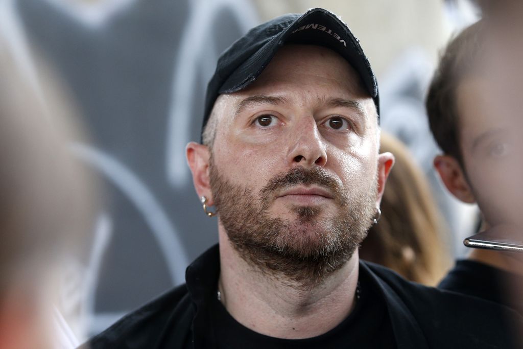 Fashion designer for Vetements, Demna Gvasalia talks to people at the end of his men and women's Spring/Summer 2019 collection fashion show, in Paris, on July 1, 2018. (Photo by GEOFFROY VAN DER HASSELT / AFP) (Photo by GEOFFROY VAN DER HASSELT/AFP via Getty Images)