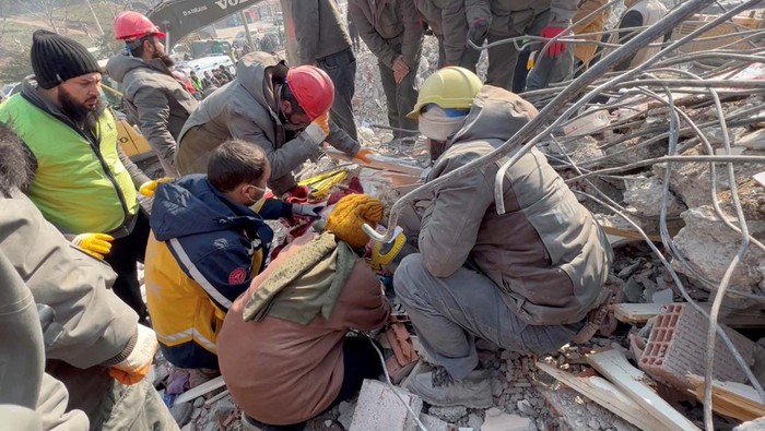 Rescuers help a woman who survived a deadly earthquake, after 128 hours under rubble, in Kahramanmaras, Turkey February 11, 2023, in this still image obtained from social media video. Courtesy of Ecir Kapisi/via REUTERS  THIS IMAGE HAS BEEN SUPPLIED BY A THIRD PARTY. MANDATORY CREDIT. NO RESALES. NO ARCHIVES.