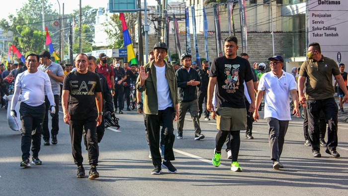 Presiden Joko Widodo (kedua kanan) didampingi Gubernur Sumatera Utara Edy Rahmayadi (kiri) dan Walikota Medan (ketiga kiri) menyapa warga  saat Car Free Day (CFD)  di Kota Medan, Suamtera Utara, Minggu (12/2/2023). Selain menyapa warga yang berolahraga di CFD, Presiden juga meninjau pembangunan sejumlah fasilitas yang ada di Kota Medan. ANTARA FOTO/Yudi/Lmo/YU