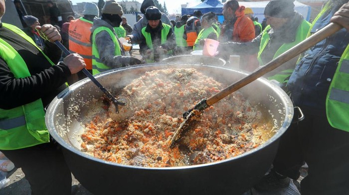 Melihat Kerja Keras Relawan di Dapur Umum Gempa Turki Volunteers prepare some food for quake-hit residents at a stadium in Kahramanmaras on February 10, 2023, after a 7.8-magnitude earthquake struck the country's southeast earlier in the week. (Photo by OZAN KOSE / AFP) (Photo by OZAN KOSE/AFP via Getty Images)
