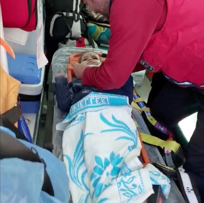 A?child?is rescued from the rubble after 150 hours in the aftermath of an earthquake in Hatay, Turkey, February 12, 2023 in this screen grab taken from a handout video. Turkish Health Ministry/ Handout via REUTERS. THIS IMAGE HAS BEEN SUPPLIED BY A THIRD PARTY.