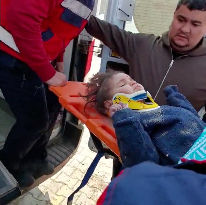 A?child?is rescued from the rubble after 150 hours in the aftermath of an earthquake in Hatay, Turkey, February 12, 2023 in this screen grab taken from a handout video. Turkish Health Ministry/ Handout via REUTERS. THIS IMAGE HAS BEEN SUPPLIED BY A THIRD PARTY.