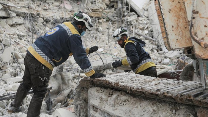 Abdel Qader Abdelrahman, a volunteer at the Syria Civil Defence (White Helmets), stands at the site of damaged buildings in the aftermath of an earthquake, in the rebel-held town of Jandaris, Syria February 10, 2023.  REUTERS/Khalil Ashawi
