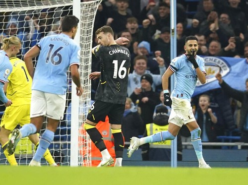 Manchester Citys Riyad Mahrez, right, celebrates after scoring his sides third goal during the English Premier League soccer match between Manchester City and Aston Villa at the Etihad Stadium in Manchester, England, Sunday, Feb. 12, 2023. (AP Photo/Dave Thompson)