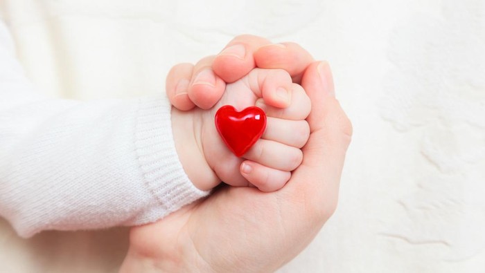 concept of love and family. hands of mother and baby closeup