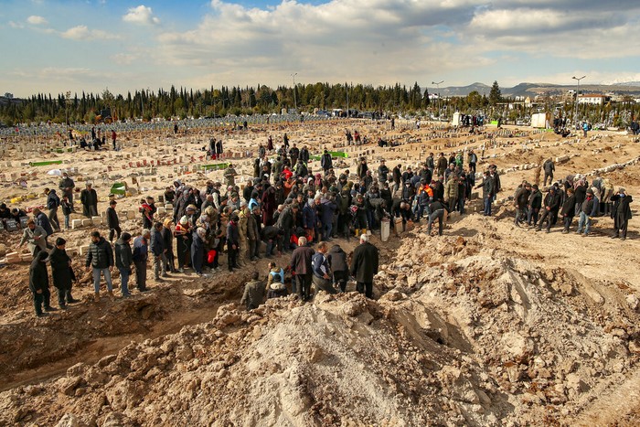 People bury their loved ones, victims of Monday earthquake, in Adiyaman, Turkey, Friday, Feb. 10, 2023. Emergency crews made a series of dramatic rescues in Turkey on Friday, pulling several people, some almost unscathed, from the rubble, four days after a catastrophic earthquake killed more than 20,000. (AP Photo/Emrah Gurel)