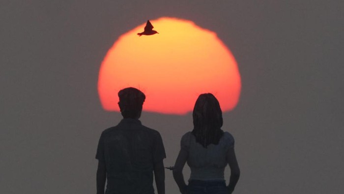 1247100373 The sunrises through the sea mist over the sculpture