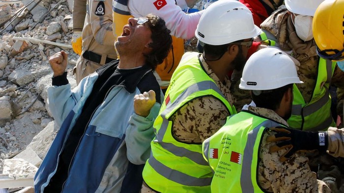 A son of a Turkish woman Saadet Sendag reacts as his mother is rescued after 177 hours, at the site of a collapsed building in the aftermath of a deadly earthquake in Hatay, Turkey February 13, 2023. REUTERS/Umit Bektas