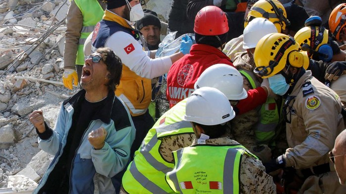 A son of a Turkish woman Saadet Sendag reacts as his mother is rescued after 177 hours, at the site of a collapsed building in the aftermath of a deadly earthquake in Hatay, Turkey February 13, 2023. REUTERS/Umit Bektas