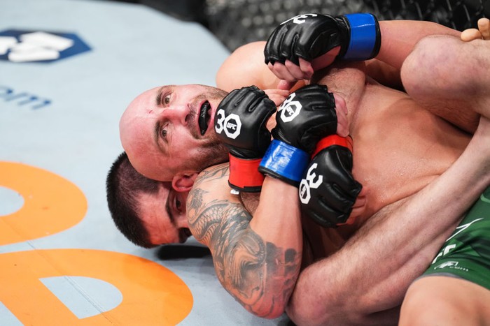 PERTH, AUSTRALIA - FEBRUARY 12: (R-L) Alexander Volkanovski of Australia battles Islam Makhachev of Russia in the UFC lightweight championship fight during the UFC 284 event at RAC Arena on February 12, 2023 in Perth, Australia. (Photo by Chris Unger/Zuffa LLC via Getty Images)