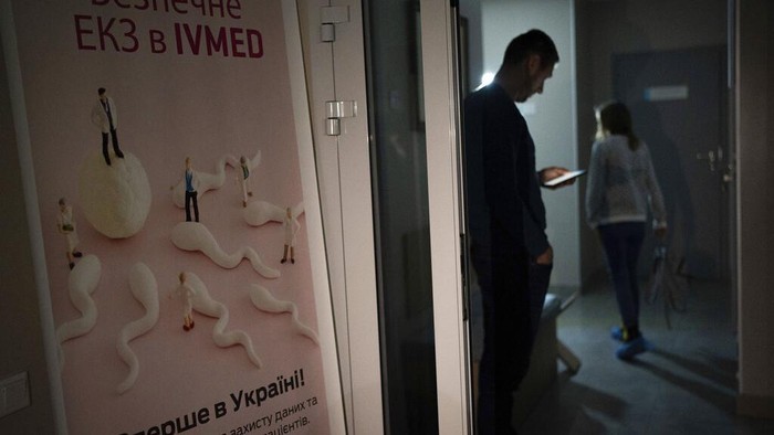 A man stands in the dark corridor of the IVMED fertility clinic during power outages in Kyiv, Ukraine, Tuesday, Jan. 31, 2023. Some Ukrainian soldiers are turning to the process of freezing sperm as they face the possibility that they might never go home. (AP Photo/Roman Hrytsyna)