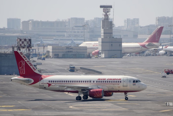 Air India Airbus A320 aircraft as seen flying over the mountains of Kathmandu valley and landing in Tribhuvan International Airport KTM. The arriving Airbus A320-200 passenger plane of the Indian carrier has the registration VT-EXD and is powered by 2x CFMI jet engines. AirIndia is the flag carrier of India, with headquarters in New Delhi, the airline is member of Star Alliance aviation group. Kathmandu, Nepal on April 2022 (Photo by Nicolas Economou/NurPhoto via Getty Images)