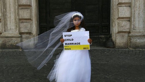 TOPSHOT - A young actress plays the role of Giorgia, 10, forced to marry Paolo, 47, during a happening organised by Amnesty International to denounce child marriage, on October 27, 2016 in Rome.  / AFP / GABRIEL BOUYS        (Photo credit should read GABRIEL BOUYS/AFP via Getty Images)