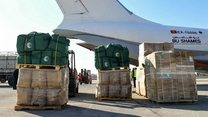 Humanitarian aid relief packages provided by Saudi Arabia for victims of the February 6 earthquake are unloaded off of an Ilyushin Il-76TD transport aircraft at Aleppo International Airport in northern Syria on February 14, 2023. - The plane carrying aid to quake-hit Syria landed in second city Aleppo on February 14 -- the first from Saudi Arabia in more than a decade of war, according to a transport ministry official. Planeloads of foreign aid have landed in Syria since a 7.8-magnitude quake struck the war-torn country and neighbouring Turkey killing more than 35,000 people. (Photo by AFP) (Photo by -/AFP via Getty Images)