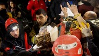 Seher nampak mengangkat kedua tangannya kala ditandu tim penyelamat. Per Rabu (15/2) jumlah korban tewas di Turki dan Suriah telah lebih dari 41.000 jiwa.