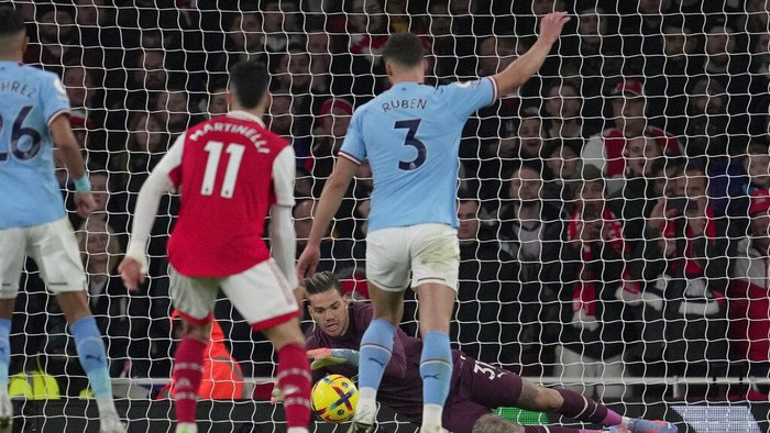 Manchester Citys goalkeeper Ederson makes a save during the English Premier League soccer match between Arsenal and Manchester City at the Emirates stadium in London, England, Wednesday, Feb.15, 2023. (AP Photo/Kin Cheung)