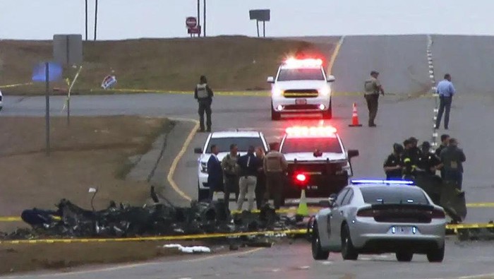 Law enforcement work at the scene of a Black Hawk helicopter crash Wednesday, Feb. 15, 2023, in the unincorporated community of Harvest, Ala. U.S. military officials say two people on board the helicopter, which was from the Tennessee National Guard, were killed. (Chris Montgomery via AP)