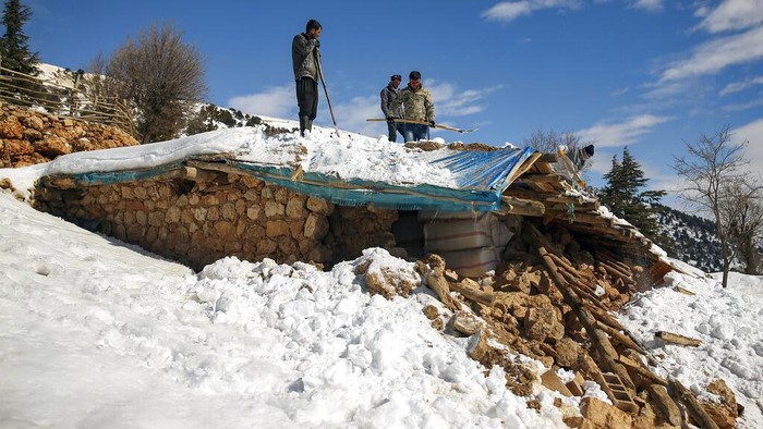 A dead cow lies on the snow near a collapsed house in Buyuknacar village in Kahramanmaras, Turkey, Wednesday, Feb. 15, 2023. More than 35,000 people have died in Turkey as a result of last week's earthquake, making it the deadliest such disaster since the country's founding 100 years ago. While the death toll is almost certain to rise even further, many of the tens of thousands of survivors left homeless were still struggling to meet basic needs, like finding shelter from the bitter cold. (AP Photo/Emrah Gurel)