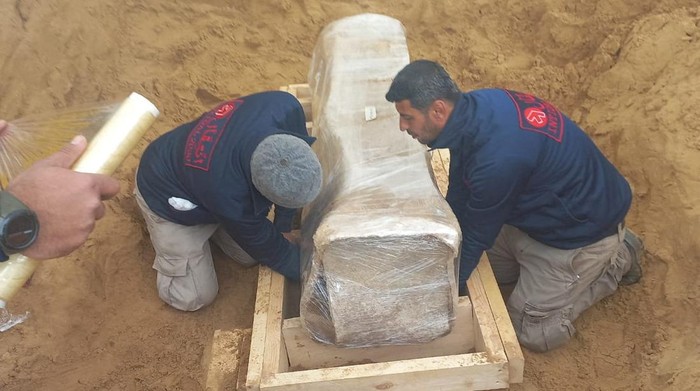 A team of archeological experts and workers, preserve a newly-discovered Roman coffin in a wooden box at the site of a 2000-year-old Roman cemetery in northern Gaza Strip February 14, 2023. Government Media Office/Handout via REUTERS??ATTENTION EDITORS - THIS IMAGE WAS PROVIDED BY A THIRD PARTY. NO RESALES. NO ARCHIVES.