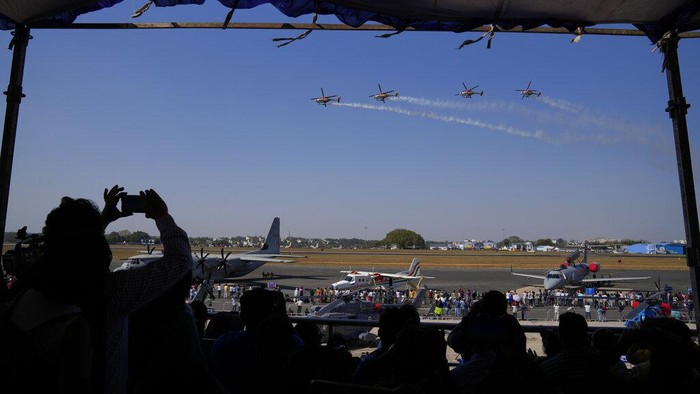 Indian Air Force's aerobatic team Suryakiran perform maneuvers on the first day of the Aero India 2023 at Yelahanka air base in Bengaluru, India, Monday, Feb. 13, 2023. Aero India is a biennial event with flying demonstrations by stunt teams and militaries and commercial pavilions where aviation companies display their products and technology. (AP Photo/Aijaz Rahi)