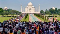 Taj Mahal, India. Berkunjung ke Taj Mahal, turis tidak lagi bisa menikmati detail arsitektur dan keagungan bangunannya. Para turis harus berdesak-desakan karena terlalu ramai dan komersialisasi di berbagai sudutnya. Belum lagi penjaja souvenir dan pemandu yang sangat agresif menawarkan jasa. Saat ini turis memilih kunjungan di jam yang tidak ramai atau lokasi sekitar yang lebih tenang. Foto: Pawan Sharma/AFP/Getty Images