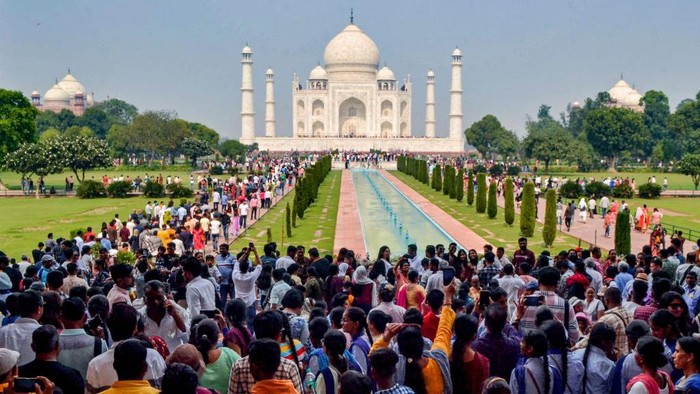 In this photograph taken on October 29, 2022, tourists visit the Taj Mahal in Agra. - India is projected to see an explosion in its urban population in the coming decades, but its cities already cannot cope and climate change will make living conditions harsher still. - To go with India-Population-Climate-Health, FOCUS (Photo by Pawan SHARMA / AFP) / To go with India-Population-Climate-Health, FOCUS (Photo by PAWAN SHARMA/AFP via Getty Images)