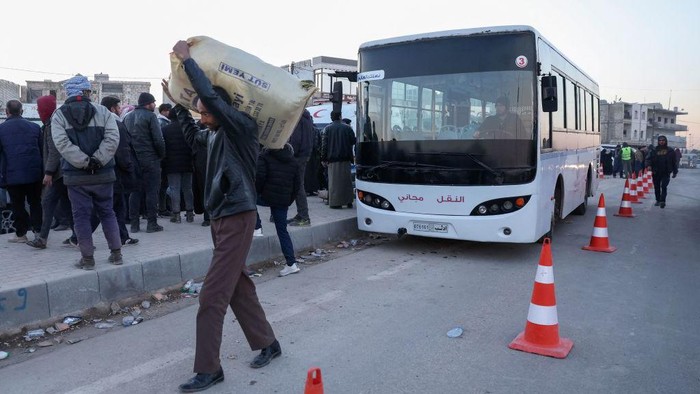 1247228600 An aerial picture shows Syrian refugees living in Turkey waiting to take a bus through the northern Bab al-Hawa border crossing, on February 17, 2023, as they return to Syria in the aftermath of a deadly earthquake. - Turkey this week allowed Syrians under its protection who hold ID cards from one of the quake-hit provinces to leave for between three and six months, a rule change designed to reunite families on both sides of the border hit by the February 6 disaster, which has killed more than 41,000 people and displaced millions across both countries. (Photo by Omar HAJ KADOUR / AFP) (Photo by OMAR HAJ KADOUR/AFP via Getty Images)