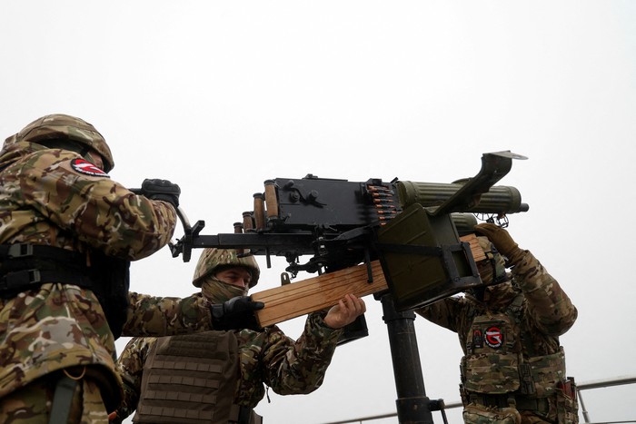 Hairdresser and Ukrainian Territorial Defence unit volunteer Oleksandr Shamshur, 41-year-old, and his mates check Maxim machine guns before ending of their shift as they guard sky over capital against Russian suicide drones, amid Russias attack on Ukraine, in Kyiv, Ukraine February 3, 2023. REUTERS/Valentyn Ogirenko