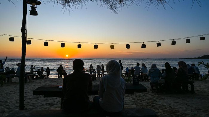 Menikmati Indahnya Sunset di Pantai Lhoknga Aceh People enjoy the sunset at a beach cafe at Lhoknga, Indonesia's Aceh province on February 18, 2023. (Photo by CHAIDEER MAHYUDDIN / AFP) (Photo by CHAIDEER MAHYUDDIN/AFP via Getty Images)