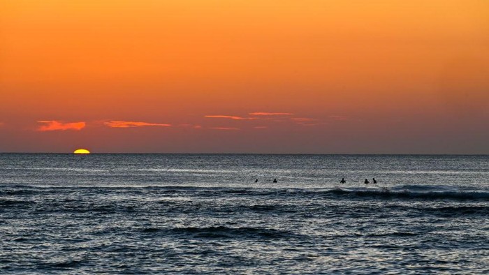 People enjoy the sunset at a beach cafe at Lhoknga, Indonesias Aceh province on February 18, 2023. (Photo by CHAIDEER MAHYUDDIN / AFP) (Photo by CHAIDEER MAHYUDDIN/AFP via Getty Images)