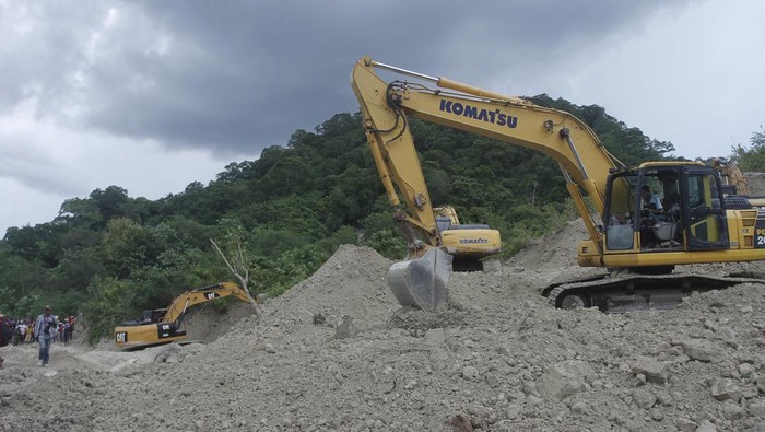 Penampakan Longsor di Kupang yang Lumpuhkan Akses 6 Kabupaten Sejumlah warga melintas di samping area materail longsor yang menutupi jalan trans Pulau Timor di Desa Oelmina, Kecamatan Takari, Kabupaten Kupang, NTT, Minggu (19/2/2023). Longsor yang terjadi pada Jumat (17/2/2023) malam tersebut mengakibatkan tesrputusnya akses transportasi yang menghubungkan wilayah pulau Timor mulai dari Kota Kupang, Kabupaten Kupang, Kabupaten Timor Tengah Selatan, Kabupaten Timor Tengah Utara, Kabupaten Belu, Kabupaten Malaka, serta negara Timor Leste. ANTARA FOTO/Kornelis Kaha/YU