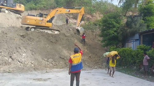 Sejumlah alat berat dikerahkan untuk membersihkan material longsor di ruas Jalan Timor Raya di Kelurahan Takari, Kecamatan Takari, Kabupaten Kupang, Nusa Tenggara Timur (NTT), Minggu (19/2/2023). (Foto: Yufen Ernesto/detikBali)