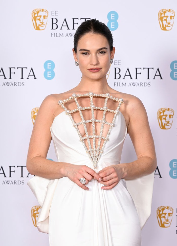 1467685140 LONDON, ENGLAND - FEBRUARY 19: Lily James poses during the EE BAFTA Film Awards 2023 at The Royal Festival Hall on February 19, 2023 in London, England. (Photo by Gareth Cattermole/BAFTA/Getty Images for BAFTA)