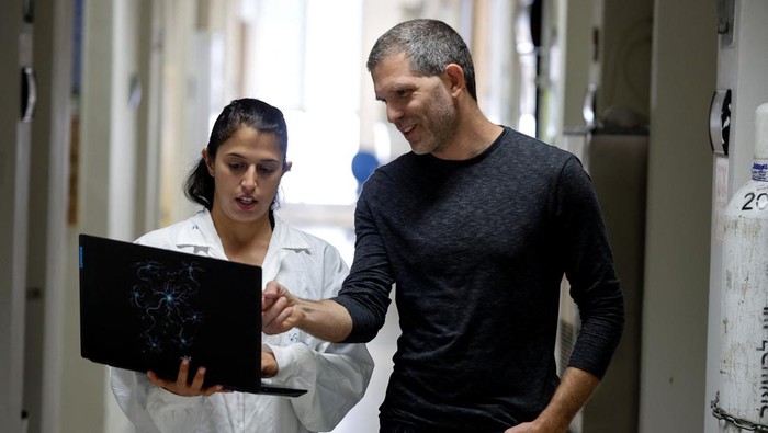Ilmuwan Israel Bikin Robot Pengendus Penyakit dengan Antena Belalang A scientist holds a newly-developed robot that, when fitted with a locust antenna, can detect and identify odours, at the Tel Aviv University, in Tel Aviv, Israel January 25, 2023. REUTERS/Amir Cohen