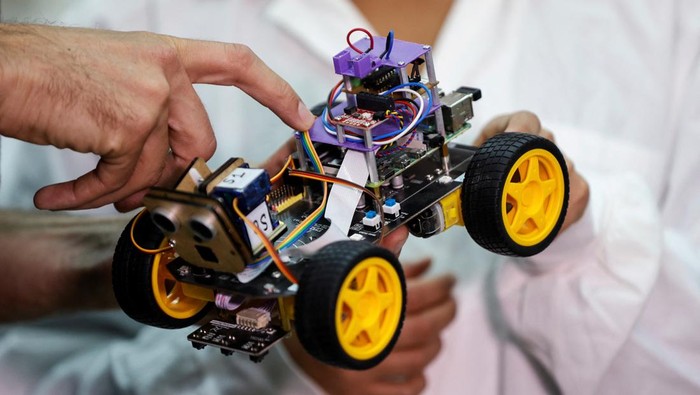 A scientist holds a newly-developed robot that, when fitted with a locust antenna, can detect and identify odours, at the Tel Aviv University, in Tel Aviv, Israel January 25, 2023. REUTERS/Amir Cohen