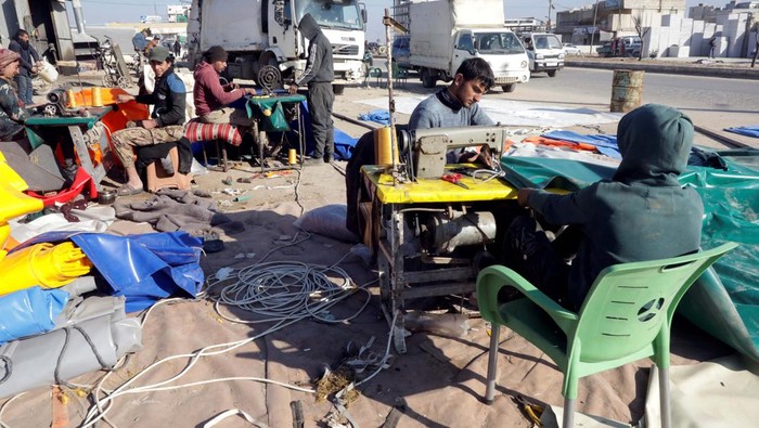 People work at a blacksmithing and tent making workshop, in the aftermath of a deadly earthquake, in the rebel-held northwestern Syrian city of Azaz, Syria February 18, 2023.  REUTERS/Mahmoud Hassano