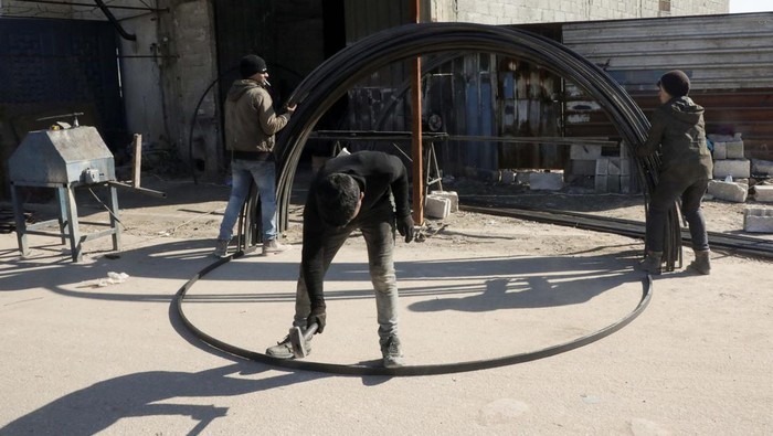 Korban Gempa Suriah Bertambah, Bengkel Ini Banjir Order Tenda Pengungsi People work at a blacksmithing and tent making workshop, in the aftermath of a deadly earthquake, in the rebel-held northwestern Syrian city of Azaz, Syria February 18, 2023. REUTERS/Mahmoud Hassano