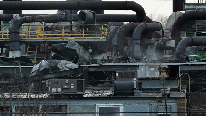 A vehicle is destroyed by a brick wall that fell from the I Schumann & Co. metals plant after an explosion at the factory in Bedford, Ohio, U.S., February 20, 2023.  REUTERS/Aaron Josefczyk