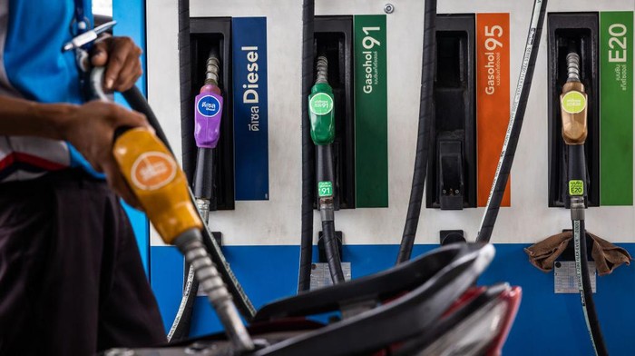An employee refuels a customers motorcycle at a PTT Pcl gas station in Bangkok, Thailand, on Wednesday, Feb. 15, 2023. PTT is scheduled to report results on Thursday. Photographer: Andre Malerba/Bloomberg via Getty Images