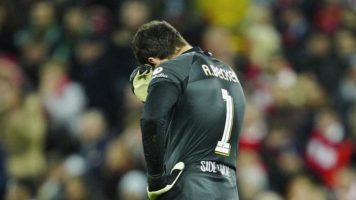 Liverpools goalkeeper Alisson gestures after Real Madrids Vinicius Junior scores his sides second goal during the Champions League, round of 16, first leg soccer match between Liverpool and Real Madrid at the Anfield stadium in Liverpool, England, Tuesday, Feb. 21, 2023. (AP Photo/Jon Super)