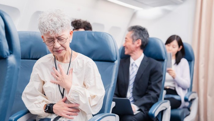 Elderly Woman Suffering from Illness on Airplane
