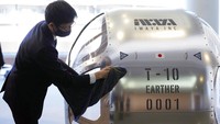 Keisuke Iwaya, CEO of a Japanese space development company, Iwaya Giken, unveils a two-seater cabin and a balloon that the company says is capable of rising to an altitude of 15 miles, which is roughly the middle of the stratosphere, as he speaks during a news conference in Tokyo, Tuesday, Feb. 21, 2023. The Japanese startup company announced plans Tuesday to launch a commercial space viewing balloon flight that it hopes will bring down to earth an otherwise astronomically expensive experience. (AP Photo/Eugene Hoshiko)