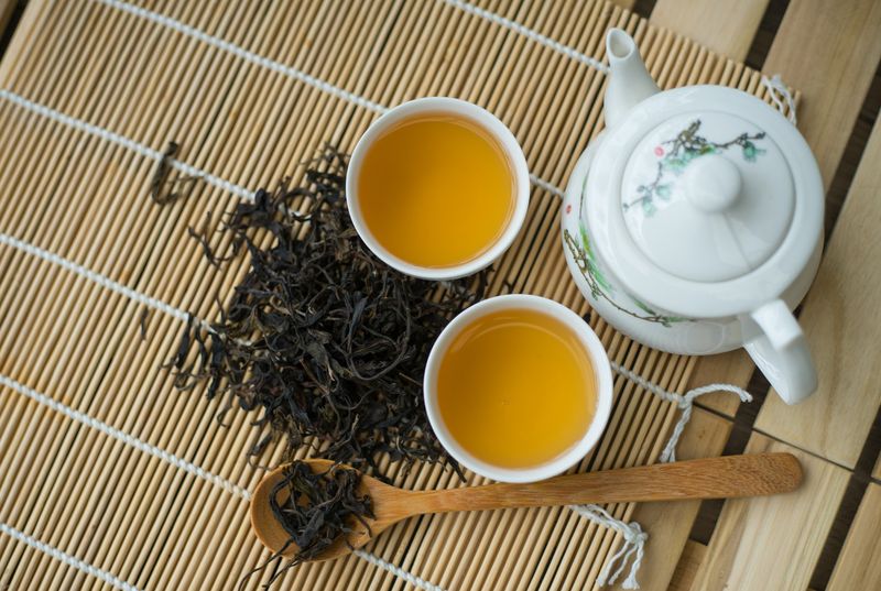 Cup with green tea on the table.
