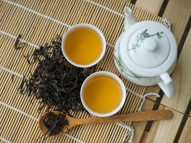 Cup with green tea on the table.