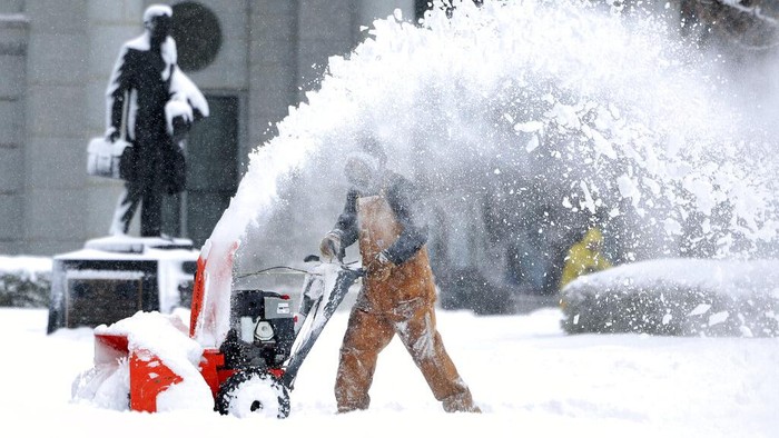 Capitol groundskeeper Mike Nielson clears the walkways at the Capitol in Salt Lake City, Utah,  following a snowstorm on Wednesday, Feb. 22, 2023.  A brutal winter storm knocked out power in California, closed interstate highways from Arizona to Wyoming and prompted more than 1,200 flight cancellations Wednesday — and the worst won't be over for several days. (Laura Seitz/The Deseret News via AP)